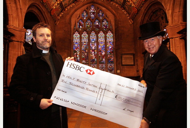 Vicar John Routh receiving Ian Hazel's donation